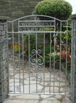 Single gate withscroll panel and house name by Kevin Gerry